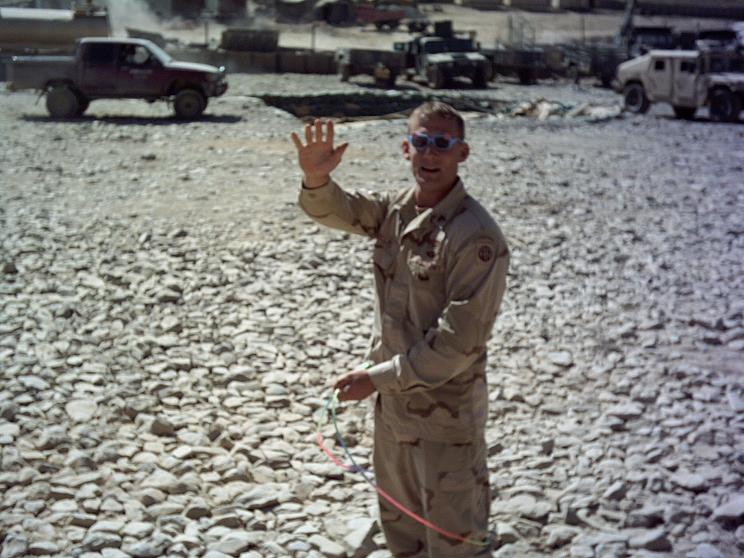 Either waving or signaling that he's still breathing!